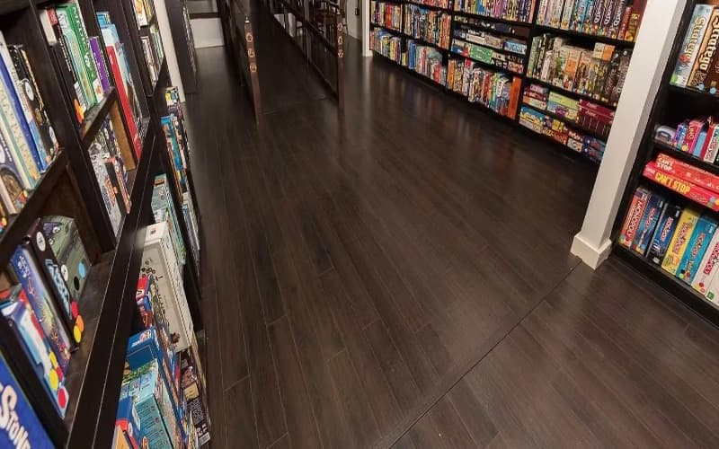 Looking down an aisle of the library, game boxes shelved from floor to ceiling on both sides
